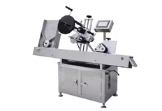 Labeling machine for cylindrical surfaces and bottles