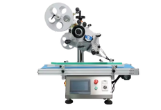 A machine for gluing labels on the upper surface